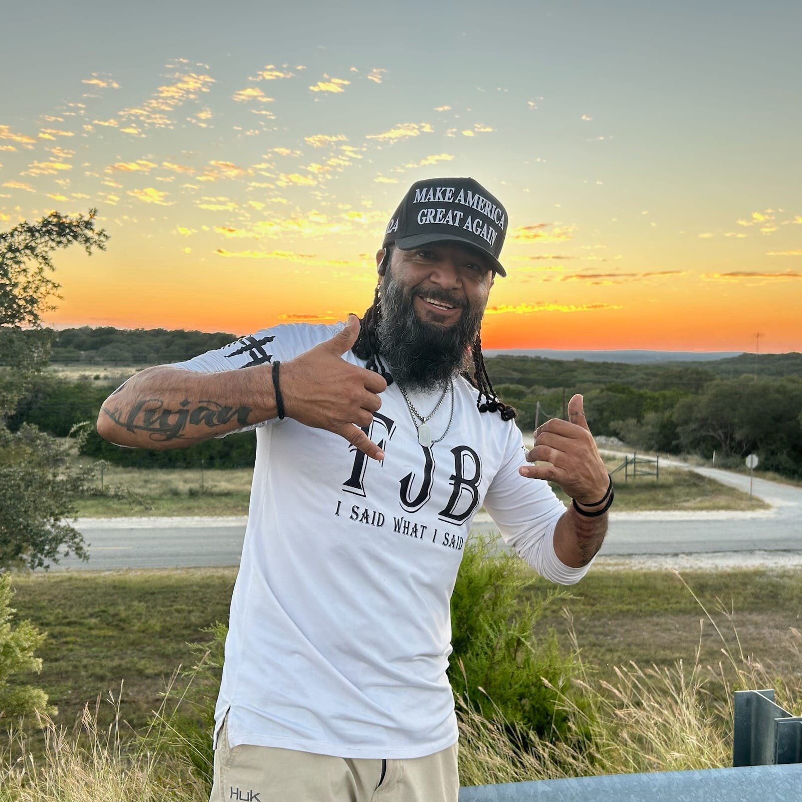 JamminLu wearing MAGA hat at sunset